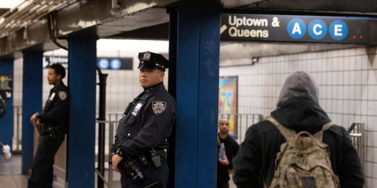 Officers patrol inside an A and C subway station in Manhattan.