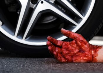 A 46-year-old man was charged with murder Tuesday for allegedly running over a man with his car on a sidewalk more than a decade ago after a spat in Brooklyn, police said