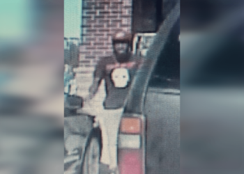 Police say John C. Drake shot at both officers outside of a Dollar General before fleeing away in a stolen vehicle.