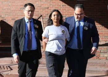 Mehwish Omer is walked from the 7th Precinct/Hate Crimes Unit in Manhattan, NY on November 27, 2023 after being charged with assault 3 hate crime.