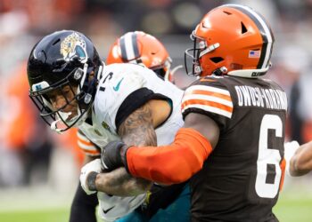 Cleveland, Ohio, USA; Jacksonville Jaguars tight end Evan Engram (17) is tackled by Cleveland Browns linebacker Jeremiah Owusu-Koramoah (6) as he runs the ball during the fourth quarter at Cleveland Browns Stadium.