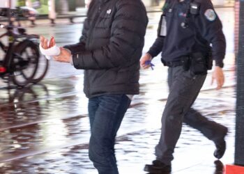 A man who was slashed in the hand in the subway at 42nd St.  Monday, Jan. 29, 2024, walks to an ambulance for treatment.