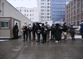NYC Migrants. Friday, January 19, 2024 PICTURED: Migrants seen awaiting to be admitted into a Men's Migrant Super Center on Hall street in Brooklyn. The shelter houses around 2000 migrants.