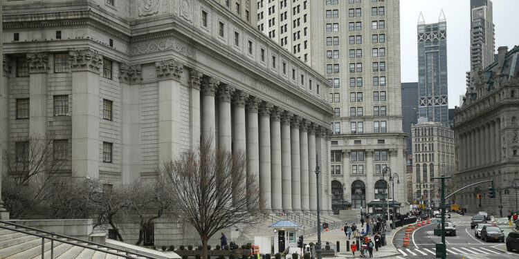 A gray building with a sign reads: "United States Courthouse."