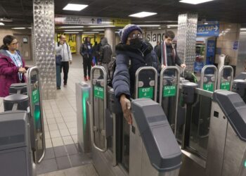 010924 Showing how NYPost Reporter Georgette Roberts is holding her Hand on a sensor to open the Gate to her right without paying, at the new Fare gates, designed to keep fare-jumpers and fare-beaters out, at the Subway Lines J and Z at Jamaica Station at 93-43 Sutphin Blvd. in Queens, NY. "NYPostinhouse"