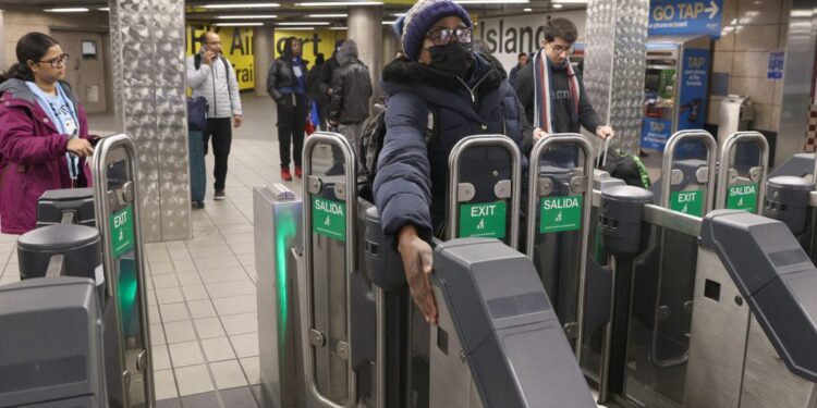 010924 Showing how NYPost Reporter Georgette Roberts is holding her Hand on a sensor to open the Gate to her right without paying, at the new Fare gates, designed to keep fare-jumpers and fare-beaters out, at the Subway Lines J and Z at Jamaica Station at 93-43 Sutphin Blvd. in Queens, NY. "NYPostinhouse"