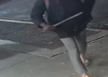 Surveillance footage shows the assailant walking on the sidewalk clutching the baseball bat.