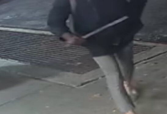 Surveillance footage shows the assailant walking on the sidewalk clutching the baseball bat.