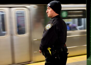An NYPD Officer is seen at the platform at 116th Street and Lexington Avenue Subway station in New York City.