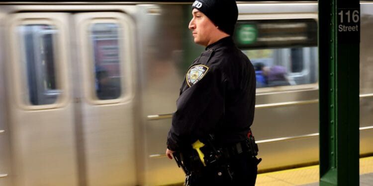 An NYPD Officer is seen at the platform at 116th Street and Lexington Avenue Subway station in New York City.