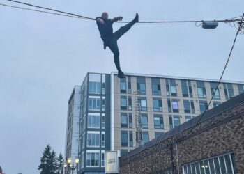 The suspect was dangling from a 20-foot cable before he dropped down on to a Washington state fire truck.
