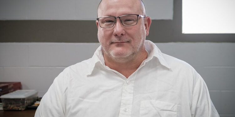Brian Dorsey, a White man with glasses wearing a white shirt, at the Potosi Correctional Center.