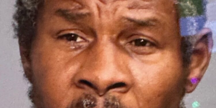 Man with a beard, identified as Alvin Doris, following two young boys selling candy on a subway platform at Broadway-Lafayette station.