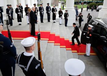 President Joe Biden (C), and first lady Jill Biden (L) welcome Japanese Prime Minister Fumio Kishida (R) to a state dinner at the White House on April 10, 2024 in Washington, DC.
