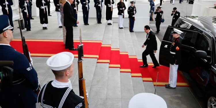 President Joe Biden (C), and first lady Jill Biden (L) welcome Japanese Prime Minister Fumio Kishida (R) to a state dinner at the White House on April 10, 2024 in Washington, DC.