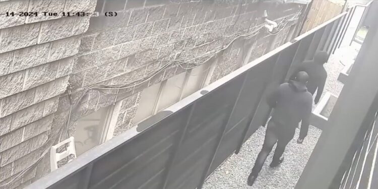 The intruder walks toward the home.