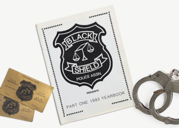 From left, Black Shield Club business cards, a Black Shield yearbook and handcuffs.