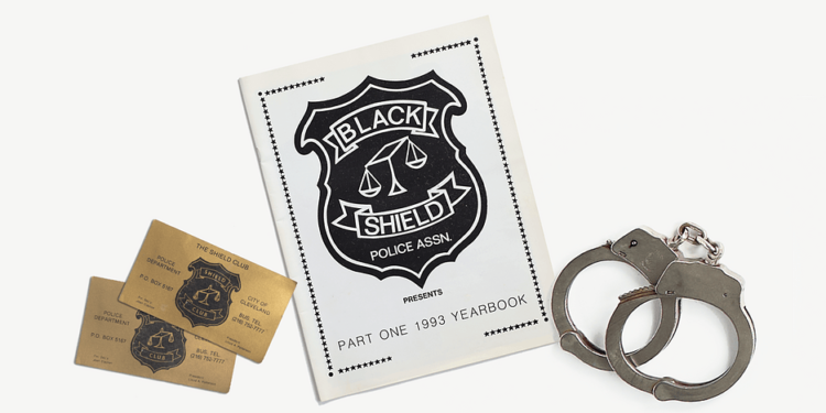 From left, Black Shield Club business cards, a Black Shield yearbook and handcuffs.
