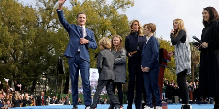 Governor Gavin Newsom, alongside his wife Jennifer Lynn Siebel Newsom and their four children, being sworn in for his second term by Chief Justice Patricia Guerrero at the Capitol Mall in Sacramento, CA.