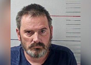 Two men wearing Halloween masks while breaking into a comic bookstore