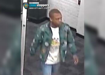 The suspected rapist was seen wearing blue jeans, a white shirt with a design on the front and a jacket with a camouflage pattern.