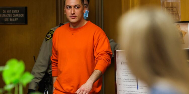 Nima Momeni in orange uniform entering the Hall of Justice courtroom for his arraignment in the case of fatal stabbing of Cash App founder Bob Lee
