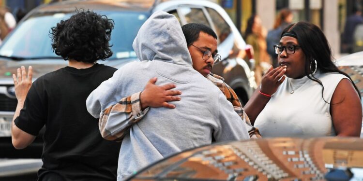People gather after a fatal stabbing occurred inside 65 W 96 St., NYC