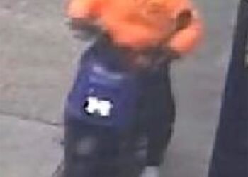 screenshot of surveillance footage which shows the suspected perp riding his blue moped on the sidewalk in the bronx