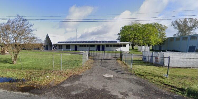 A fenced-in area with a building and trees, identified as Feather River School of Seventh-Day Adventist in California