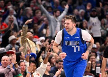 Dallas Mavericks guard Luka Doncic (77) celebrates after making a basket against the Minnesota Timberwolves during the first quarter at the American Airlines Center.