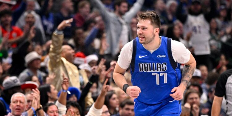Dallas Mavericks guard Luka Doncic (77) celebrates after making a basket against the Minnesota Timberwolves during the first quarter at the American Airlines Center.