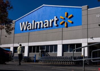 A man walking past a Walmart store in Martinez, California ahead of its earnings release