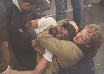 Penny putting jordan neely in a chokehold as they laid on the floor of the subway train