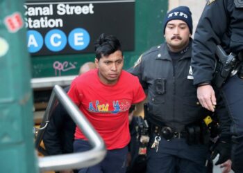 NYPD officers escort suspect Sebastian Zepata-Calil, wanted for a homicide on the subway in Coney Island, out of TD2 in lower Manhattan Sunday, Dec. 22, 2024.