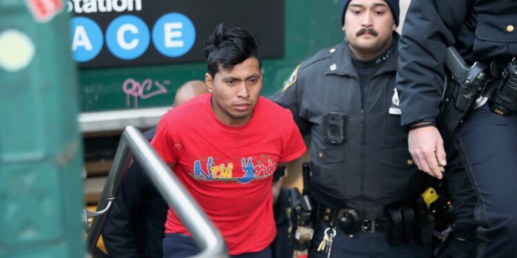 NYPD officers escort suspect Sebastian Zepata-Calil, wanted for a homicide on the subway in Coney Island, out of TD2 in lower Manhattan Sunday, Dec. 22, 2024.