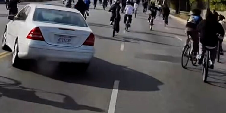 Los Angeles driver nearly hits massive group of teenage bicyclists (Video)
