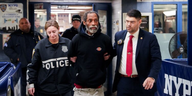 NYPD officers walk Jamar Banks out of Transit Bureau District 2 station in New York City, U.S., January 5, 2025.
