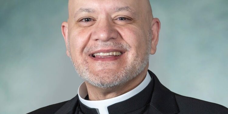 Father Carlos Martins, 50, was arrested and charged with misdemeanor battery.
