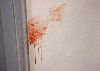 photo shows blood smeared on a wall at the scene of a fatal stabbing in Brooklyn
