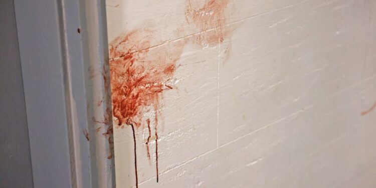 photo shows blood smeared on a wall at the scene of a fatal stabbing in Brooklyn