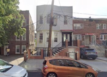 A 55-year-old woman was hospitalized after she was struck in the forehead by a stray bullet on Sunday night.