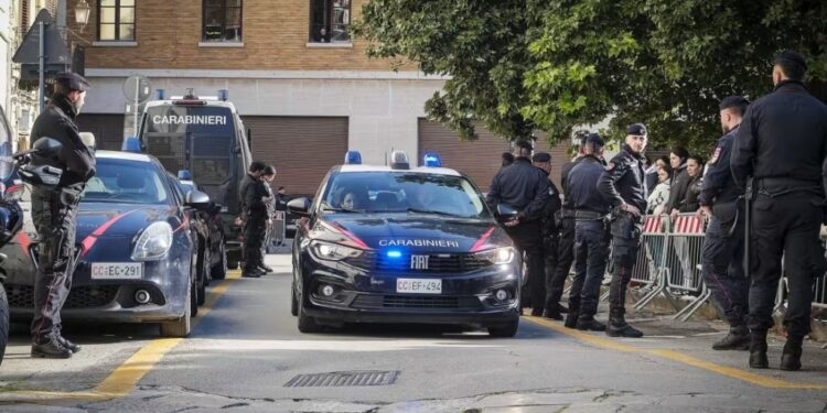 A group of police officers standing around a car with celebrities Collie Buddz, Shahindokht Molaverdi, and Jacqueline Kim