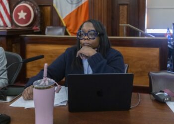 City Councilwoman Althea Stevens sitting at a table with a laptop and a cup during the Committee on Public Safety hearing on February 24, 2025