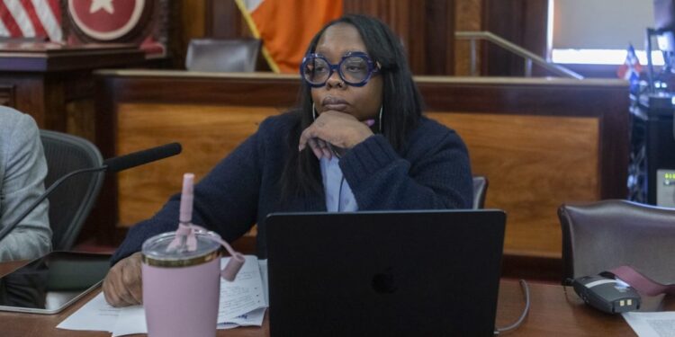 City Councilwoman Althea Stevens sitting at a table with a laptop and a cup during the Committee on Public Safety hearing on February 24, 2025