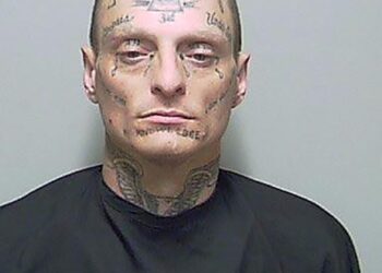 A man with tattoos on his face, identified as Thomas Carpenter, being arrested by Putnam County Sheriff's office during a traffic stop.