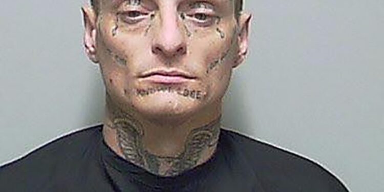 A man with tattoos on his face, identified as Thomas Carpenter, being arrested by Putnam County Sheriff's office during a traffic stop.