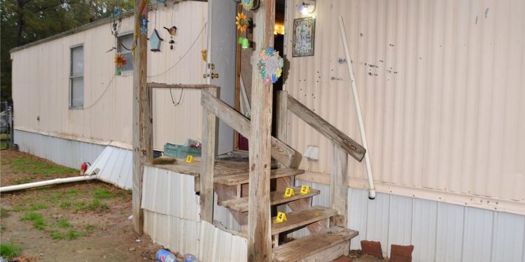 A photo shows the back entrance of a home with hanging decorations and bullet holes. Numbered yellow evidence markers are placed around the stairs leading up to the front door.