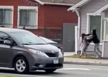 The suspect dragged the woman into his car as traffic rushed by.