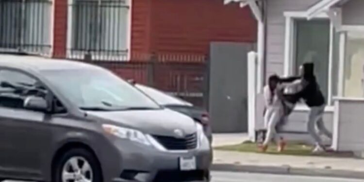 The suspect dragged the woman into his car as traffic rushed by.