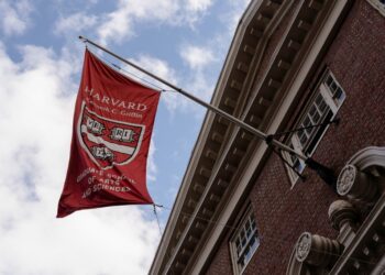 A Graduate School of Arts and Sciences flag flying on Harvard University campus, Cambridge, Massachusetts, amid escalating tensions with President Trump's administration on April 16, 2025.